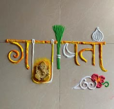 an artistic wall hanging with the word india written in different languages and symbols on it