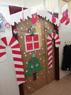 a door decorated with christmas decorations and candy canes