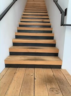 a set of wooden stairs leading up to the second floor