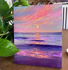 an acrylic painting of a sunset over the ocean with purple and pink colors