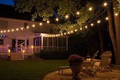 an outdoor patio with string lights and chairs