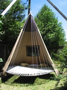 an image of a bed made out of a hammock hanging from a pole