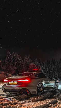 a car parked in the snow at night