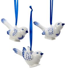 three ceramic bird ornaments hanging from blue ribbon