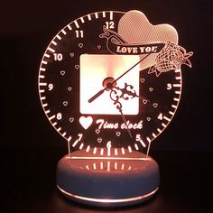 an illuminated clock with the words love you to the moon and back