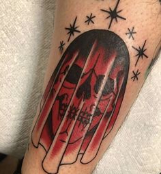 a man's leg with a skull and bars tattoo on his arm, which has stars in the background