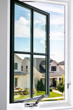 an open window with the view of houses outside