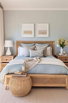 a bed with blue sheets and pillows in a bedroom