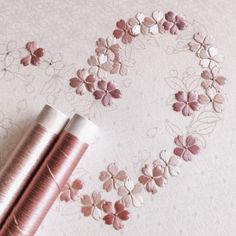 two spools of thread sitting next to each other on top of a table