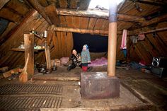 two people sitting on the floor in an attic