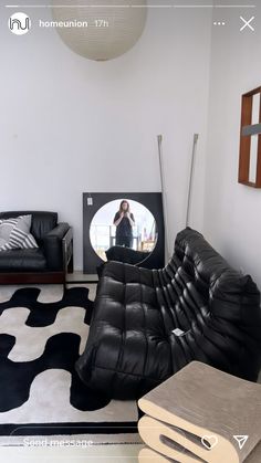 a living room filled with furniture and a flat screen tv mounted to the side of a wall