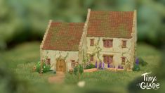 a miniature house is shown in the grass