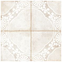 a white tile floor with an intricate design on the top and bottom half of it