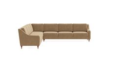 a beige sectional couch sitting on top of a white floor