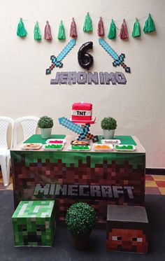 a minecraft themed birthday party with cake, decorations and table cloths on display