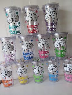 a bunch of plastic cups with hello kitty designs on them are lined up in rows