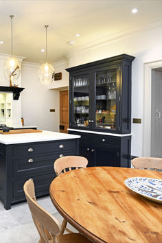 a large kitchen with an island and dining table