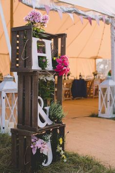 an outdoor wedding tent with flowers and lanterns