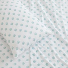 a bed with blue polka dots on it