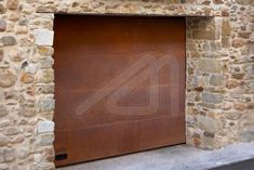 a large brown garage door sitting on the side of a stone building