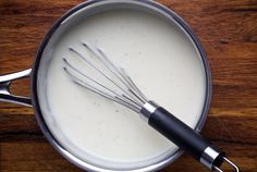 a whisk in a saucepan with milk