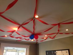 the ceiling is decorated with red and white streamers