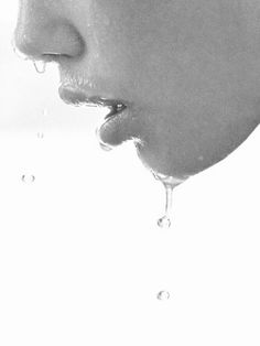 black and white photograph of a man's face with water droplets