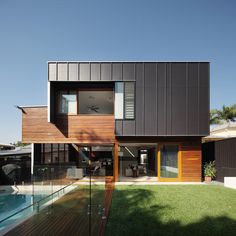 a modern house with wood siding and glass doors