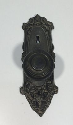 an ornate door handle with a hole in the middle and a keyhole on one side