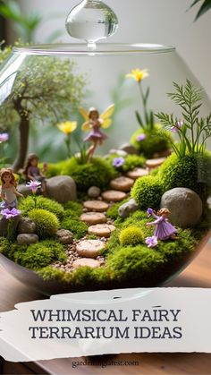 a glass bowl filled with moss and fairy figurines