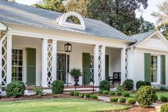 a white house with columns and green shutters