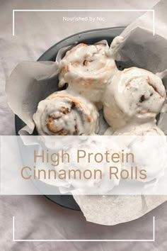 a bowl filled with cinnamon rolls covered in icing