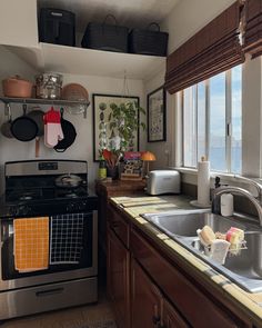 a kitchen with an oven, sink and window overlooking the water in it's reflection