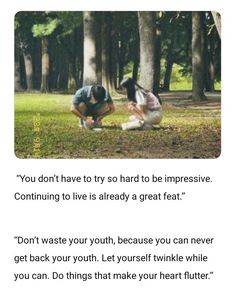 two people kneeling down in the grass near trees