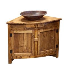 a bowl on top of a wooden cabinet with doors and drawers in the shape of a door