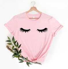 💠This shirt is made of cotton and handmade with eco-friendly screen printing. Eyelashes T-shirt in the quality of this graphic tee with its comfortable fit and softness. Casual style can make it an instant favorite in everyone's closet. Funny black eyelashes tee girls women gift for anyone who loves eyelash clothing, makeup clothing for your daily lash appointments. 💠Lashes are the perfect shirt for women or teen girls who appreciate dramatic lashes. Share your love of dramatic eyes with this Black Eyelashes, Dramatic Lashes, Artist Shirts, Dramatic Eyes, Makeup Clothes, Kindness Shirts, Mom Tees, Trendy Tee, Trendy Shirts