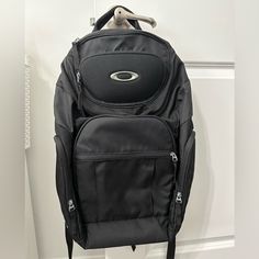 a black backpack hanging on the wall