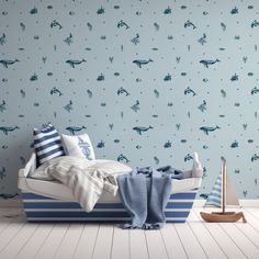 a bedroom with blue and white wallpaper, a small sailboat on the bed