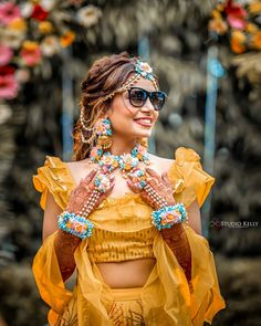 a woman in a yellow top and sunglasses