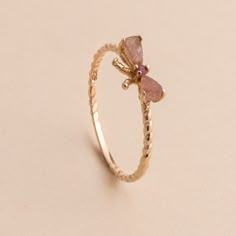 Add a little character with this bow style ring to your outfit. Handcrafted in gold plated sterling silver, this ring features genuine pink tourmaline stones and a deep red ruby gemstone. Approximate stone measurement: 3/8" x 1/4" Material: sterling silver, genuine pink tourmaline gemstone, genuine ruby gemstone Item #: 13159 FAIRPRICING $85 TOORIGINAL | $110 ESTIMATED RETAIL All of our items are priced specially while keeping the same high standard quality. Pink Stone Rings Gold, Cute Aesthetic Rings, Rings Aesthetic Pink, Cute Rings Aesthetic, Stylish Jewelry Accessories, Rings Pink, Pink Garnet, Fancy Jewelry Necklace, Bow Style