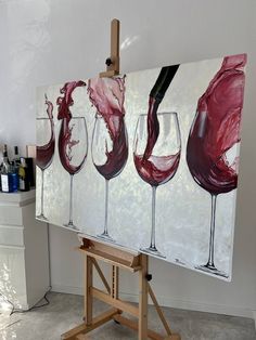 three wine glasses are being painted on a canvas