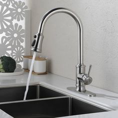 a kitchen sink with a faucet running water from it's spout