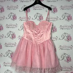 Sugar Thrillz Certain Flair Tutu Dress Pink New With Tags Corset Tie Up Back Brand New With Tags Size Large. Heart Underwire Bust , Structured Boning, Adjustable Shoulder Straps, A Layered Tutu Skirt With An Embroidered Hem, Lace Up Corset Design On The Back, And A Side Zip Closure. So Stunning And Cute. Very Flattering Love The Item But Not The Price? Offers Are Always Accepted! Feel Free To Send An Offer Bundle 2+ Items & You Will Get Sent A Discounted Offer & You Will Save $ On Shipping 5 Sta Pink Mini Corset Dress, Pink Party Corset With Ruffles, Feminine Pink Mini Corset Dress, Pink Mini-length Chic Corset Dress, Pink Maternity Maxi Dress, Pink Ruffled Party Corset, Feminine Pink Mini-length Corset Dress, Navy Blue Maternity Dress, Sugar Thrillz Dress