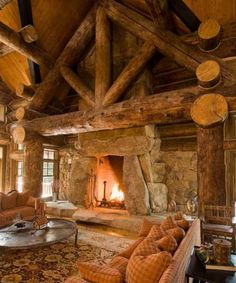 a living room with couches and a fire place in the middle of the room