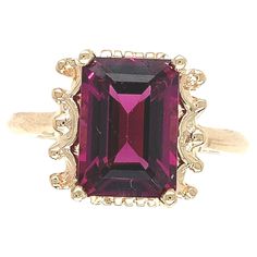 14K yellow gold ring featuring an emerald cut rhodolite garnet weighing 3.51 carats. The garnet measures about 11mm x 8mm and has purplish-raspberry color. The ring fits a size 7 finger, weighs 2.25dwt. and dates from the 1950-60's. Silverware Place Setting, Gold Ring With Emerald, Ring With Emerald, Antique Jewelry Rings, Raspberry Color, Rhodolite Garnet, Put A Ring On It, 14k Gold Ring, Ring Fit