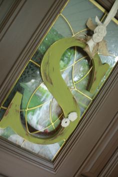 the letter s is painted green and has flowers on it