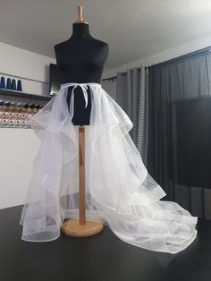 a mannequin with a white tulle skirt on it