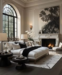 an elegant living room with white furniture and fireplace