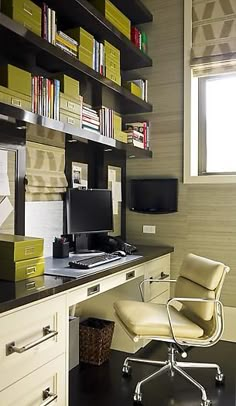 an office with a desk, chair and bookshelf