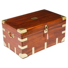 a wooden box with gold trimmings on it